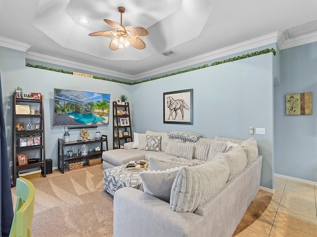 tiled living room with ornamental molding and ceiling fan