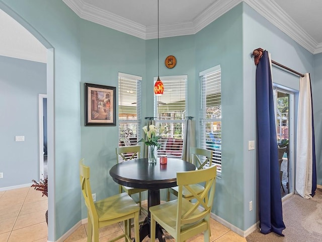 tiled dining area featuring crown molding