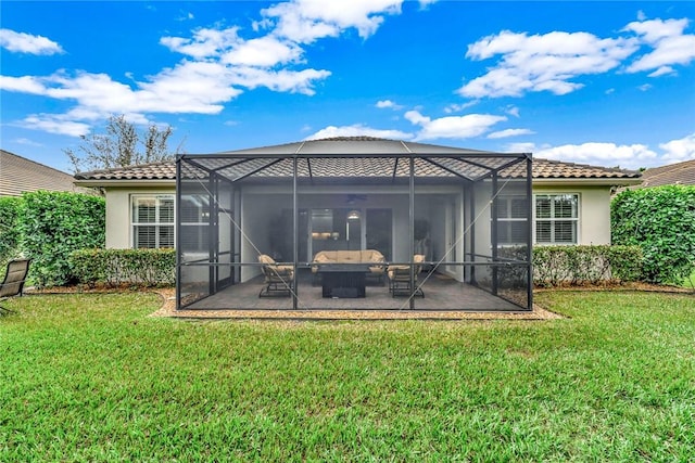 back of property featuring a lawn, outdoor lounge area, a lanai, and a patio