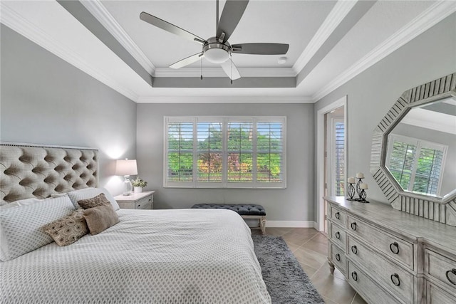 tiled bedroom with ceiling fan, crown molding, and a tray ceiling