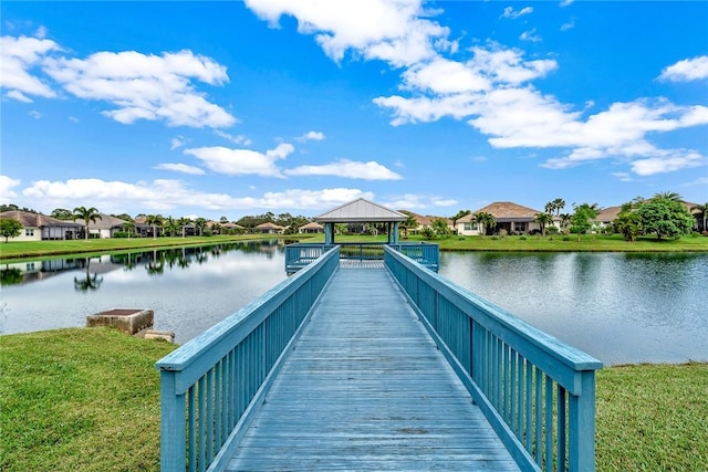 view of dock with a gazebo and a water view