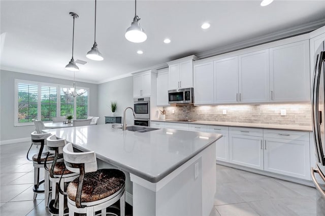 kitchen with white cabinets, a kitchen island with sink, and stainless steel appliances