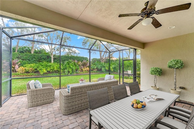 view of patio featuring glass enclosure and an outdoor living space