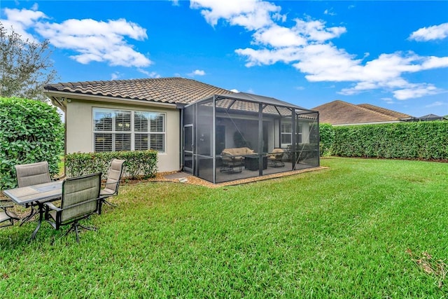 back of house with a lawn, a lanai, and a patio