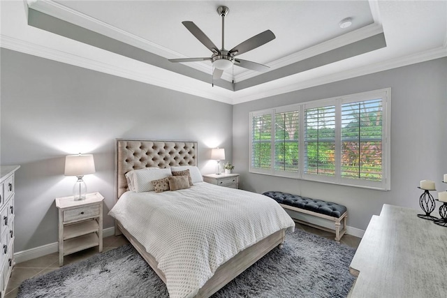 bedroom with ceiling fan, crown molding, and a tray ceiling