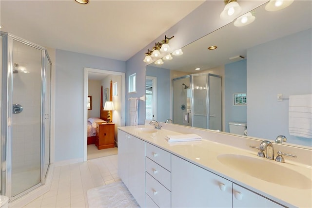 bathroom with tile patterned floors, vanity, toilet, and walk in shower