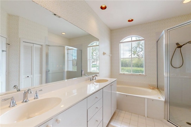 bathroom with tile patterned flooring, shower with separate bathtub, and vanity