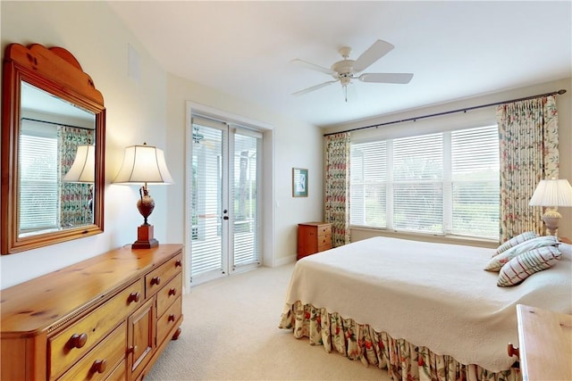 carpeted bedroom featuring access to exterior, ceiling fan, and multiple windows