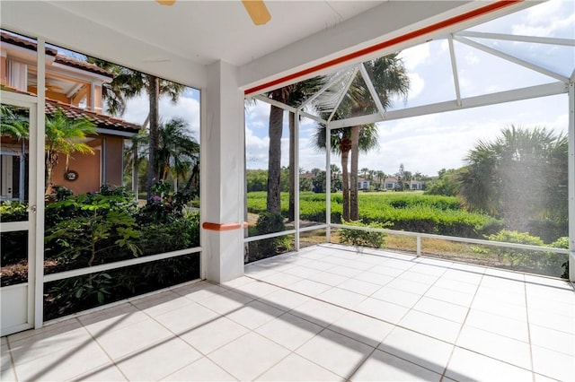 unfurnished sunroom featuring ceiling fan