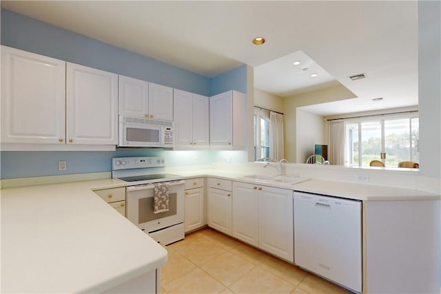 kitchen featuring kitchen peninsula, white appliances, white cabinetry, and sink