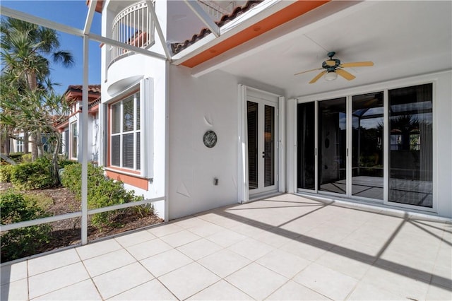 unfurnished sunroom with beam ceiling and ceiling fan