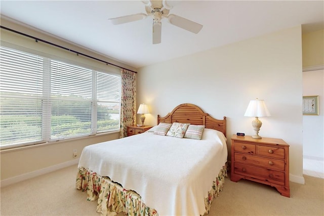 bedroom featuring ceiling fan and light colored carpet