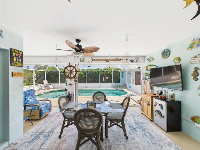 view of patio featuring an outdoor pool, a lanai, and a ceiling fan