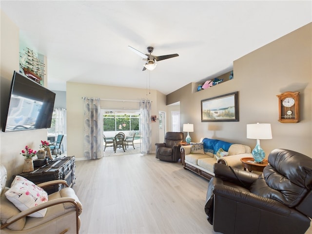 living area featuring baseboards, light wood-style floors, and ceiling fan