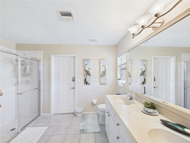 full bath with tile patterned flooring, a stall shower, visible vents, and a sink