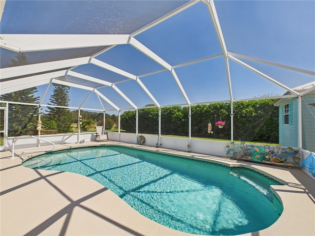 pool with glass enclosure and a patio