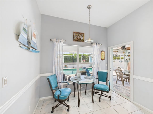 tiled dining space featuring baseboards