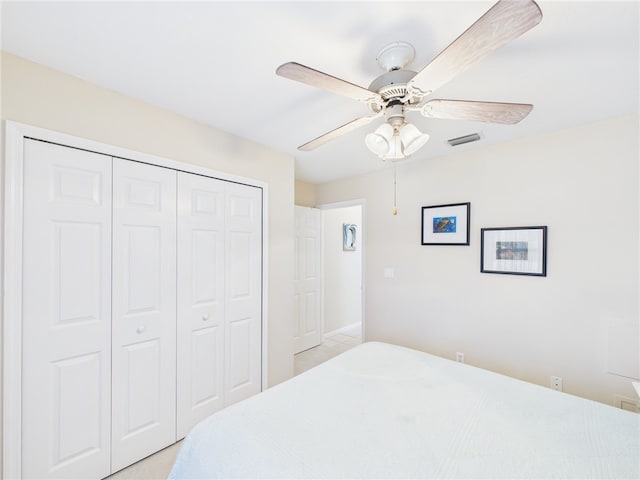 bedroom featuring a closet, visible vents, and a ceiling fan