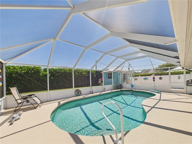 view of pool with a lanai, fence, a patio area, and a fenced in pool