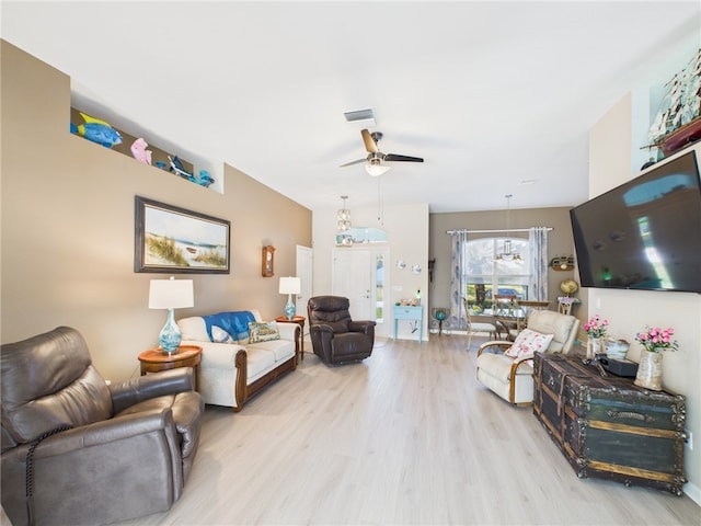 living area with light wood-type flooring, visible vents, and ceiling fan