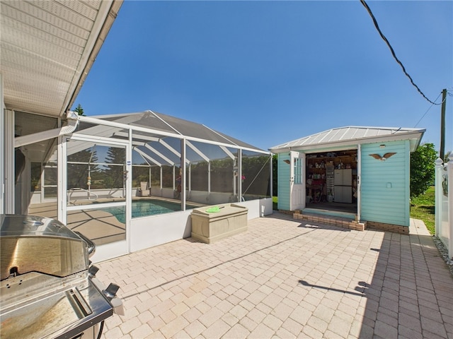 view of patio with an outdoor pool, a lanai, and an outdoor structure