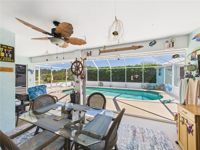 view of swimming pool with a fenced in pool and a ceiling fan