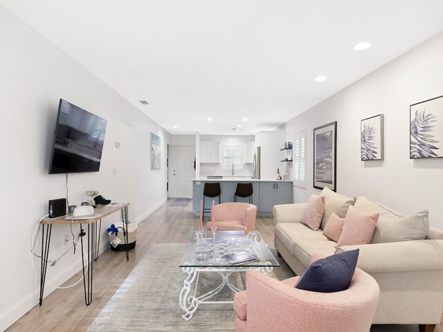 living room with light hardwood / wood-style flooring