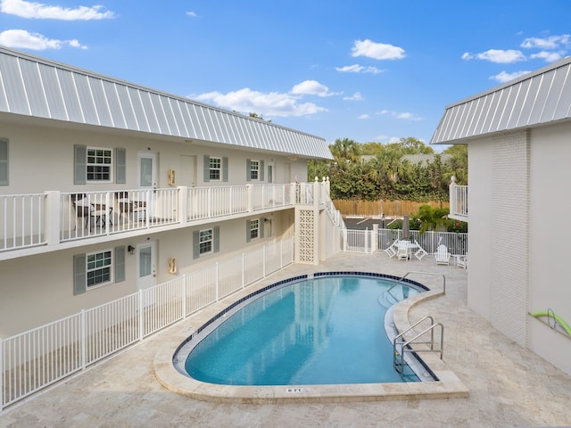 view of swimming pool featuring a patio area