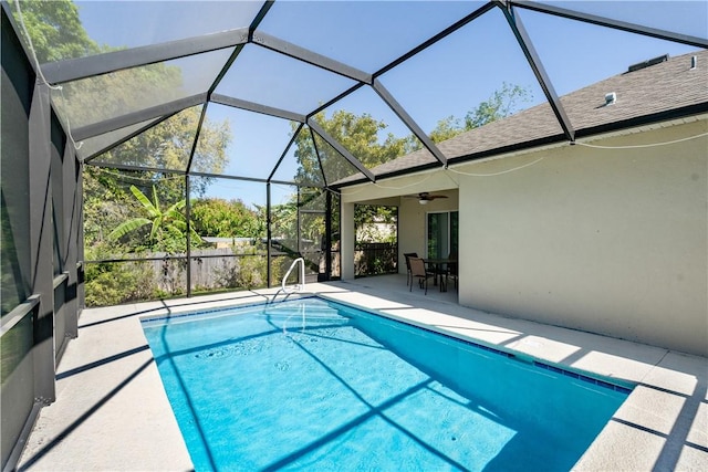 pool featuring a lanai, ceiling fan, and a patio area