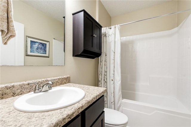 bathroom featuring vanity, shower / bath combination with curtain, toilet, and a textured ceiling