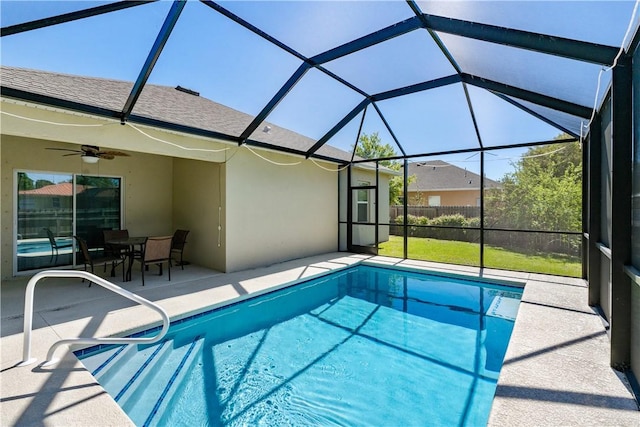 outdoor pool with a patio, a lanai, and ceiling fan