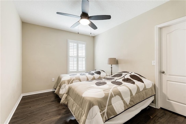 bedroom with ceiling fan, a textured ceiling, baseboards, and wood finished floors