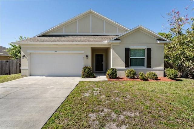 view of front facade featuring stucco siding, fence, a front yard, a shingled roof, and a garage