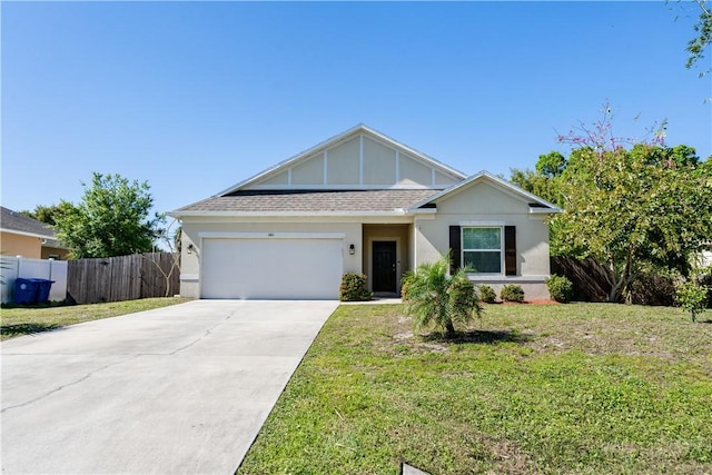 view of front of property featuring a front yard, fence, roof with shingles, an attached garage, and concrete driveway