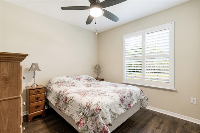 bedroom featuring ceiling fan, baseboards, and wood finished floors