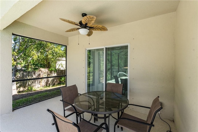 sunroom / solarium featuring a ceiling fan and a wealth of natural light