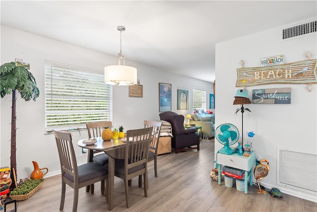 dining area featuring light wood-type flooring and plenty of natural light