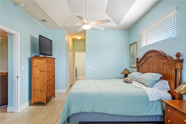 bedroom with a ceiling fan, baseboards, light tile patterned flooring, and visible vents