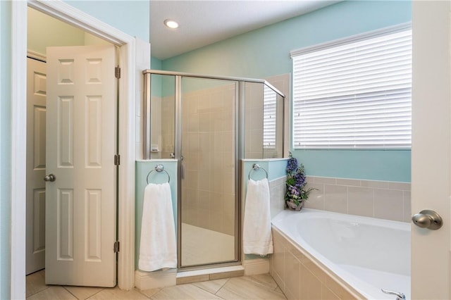 bathroom featuring a garden tub, tile patterned floors, and a stall shower