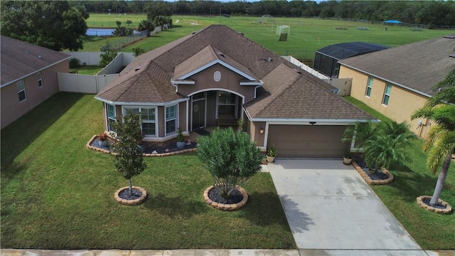 view of front of home featuring stucco siding, driveway, a shingled roof, and a garage