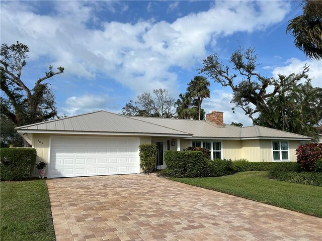 ranch-style home featuring a garage and a front yard