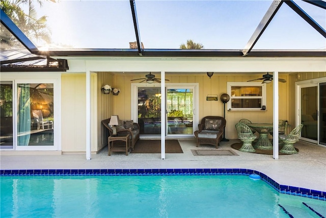 back of property with a lanai, ceiling fan, and a patio