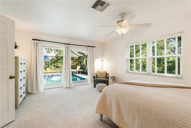 carpeted bedroom featuring ceiling fan, access to outside, and multiple windows