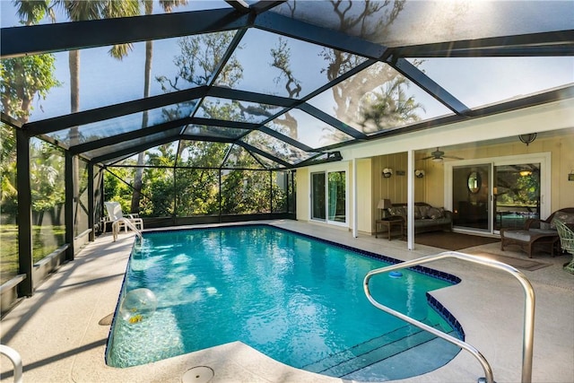 view of swimming pool with glass enclosure, an outdoor living space, ceiling fan, and a patio