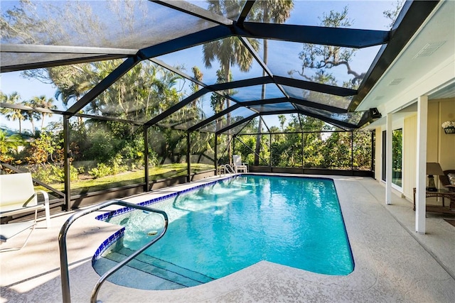 view of pool featuring glass enclosure and a patio area