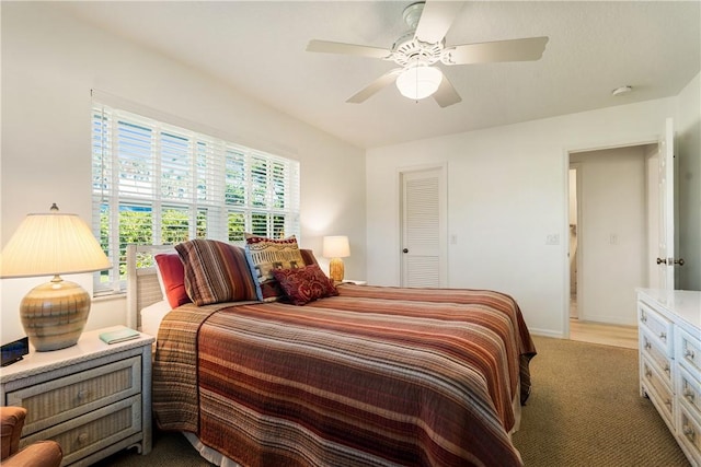 carpeted bedroom with a closet and ceiling fan