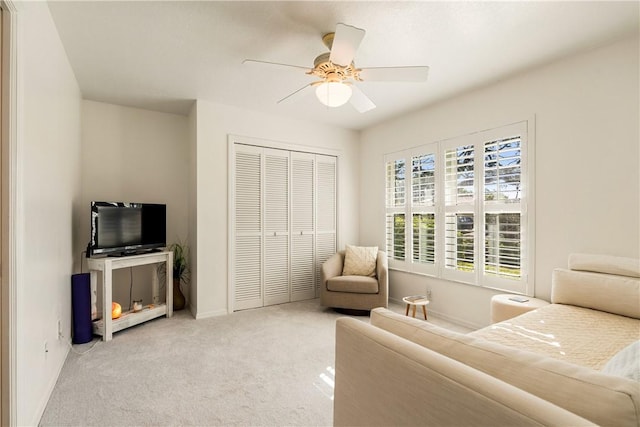 interior space featuring light carpet and ceiling fan