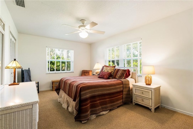 bedroom with ceiling fan and light colored carpet