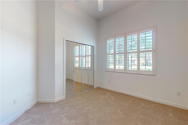 9515 E Maiden Ct, Vero Beach, FL 32963 - unfurnished bedroom featuring carpet flooring, multiple windows, and baseboards