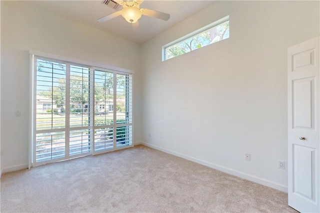 9515 E Maiden Ct, Vero Beach, FL 32963 - unfurnished room with baseboards, light carpet, visible vents, and ceiling fan